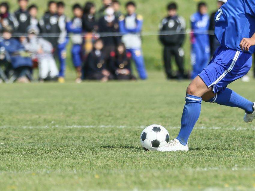 子どものサッカーを応援する保護者